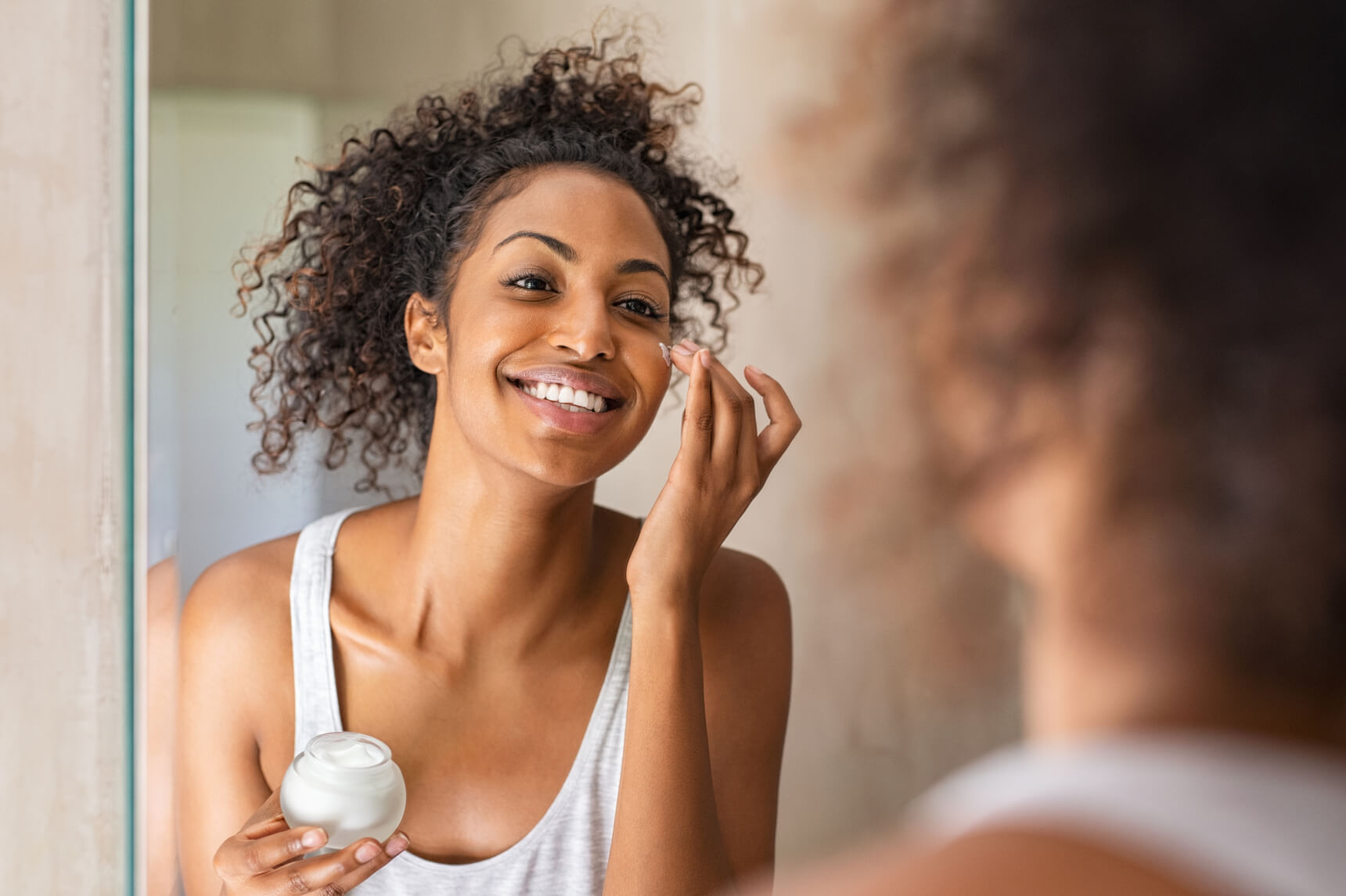 black-girl-applying-lotion-face (1) (1) (1)